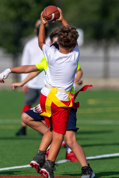Action shots of a very young and athletic boy playing flag football
