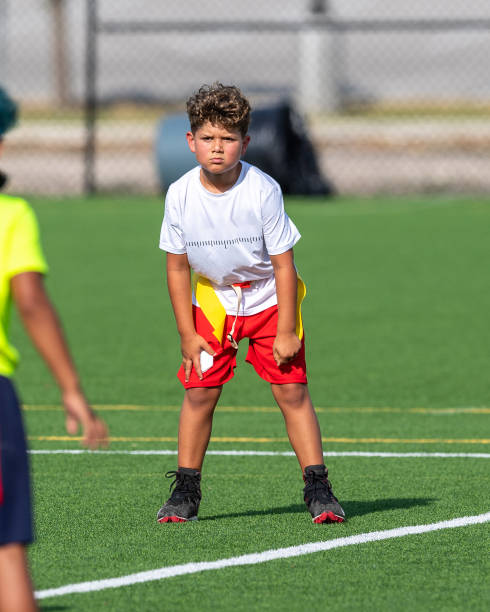 istock Young cute boy playing in a Flag Football game 1264350018