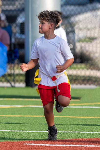 istock Young cute boy playing in a Flag Football game 1264350054