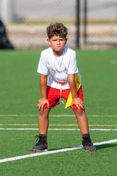 Young cute boy playing in a Flag Football game