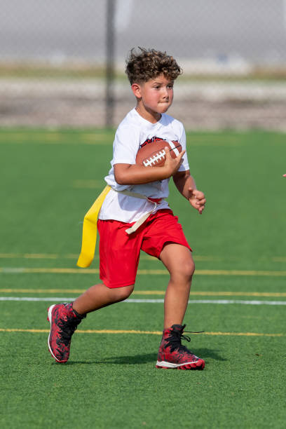 istock Young cute boy playing in a Flag Football game 1264350103