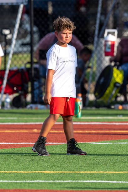istock Young cute boy playing in a Flag Football game 1264350109