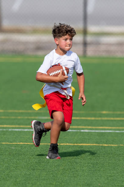 istock Young cute boy playing in a Flag Football game 1264350113