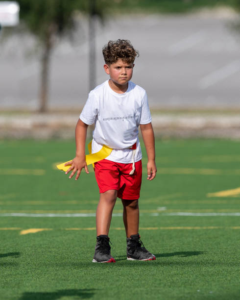 istock Young cute boy playing in a Flag Football game 1264350128