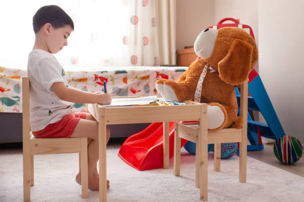 little boy drawing at home