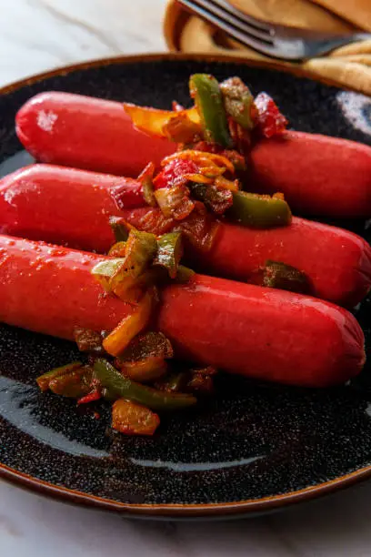 Hot spicy sausage with sliced peppers and onions