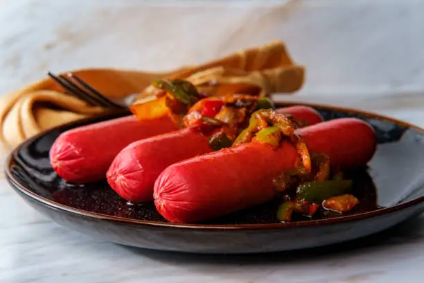 Hot spicy sausage with sliced peppers and onions