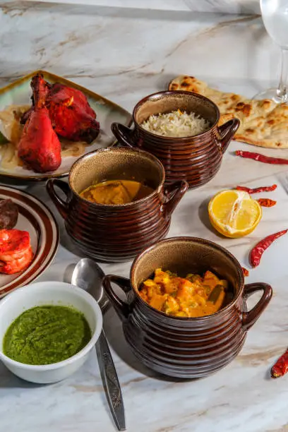 Indian vegetable korma curry lamb rogan josh and tandoori grill platter with naan and cilantro chutney