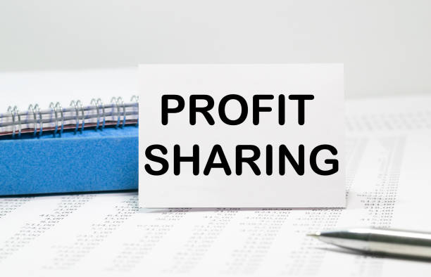 istock ON the table on the notebook is the inscription PROFIT SHARING 1264351825