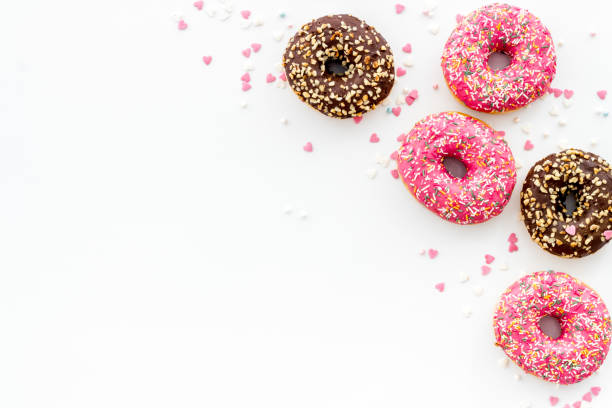 istock Colorful donuts pink and chocolate icing. Flat lay of bakery, above view 1264353050