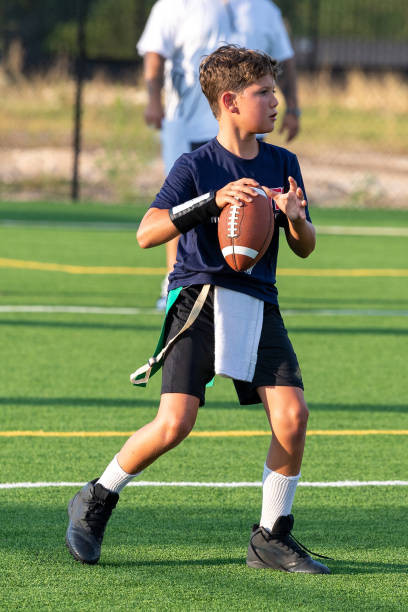 istock Young boy playing in a flag football game 1264354203