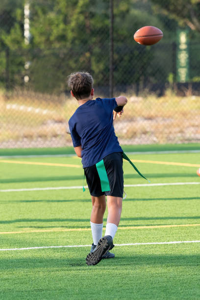 istock Young boy playing in a flag football game 1264354222