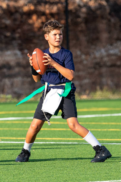 istock Young boy playing in a flag football game 1264354253