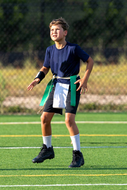istock Young boy playing in a flag football game 1264354276