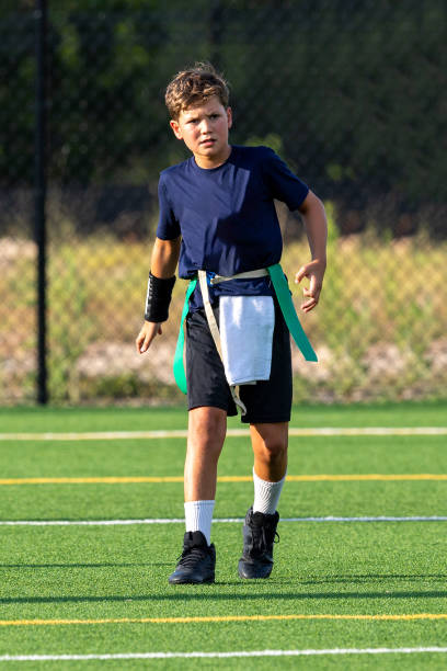 istock Young boy playing in a flag football game 1264354288