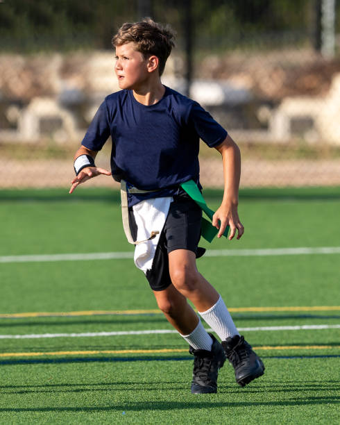 istock Young boy playing in a flag football game 1264354297