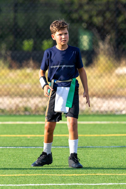 istock Young boy playing in a flag football game 1264354305