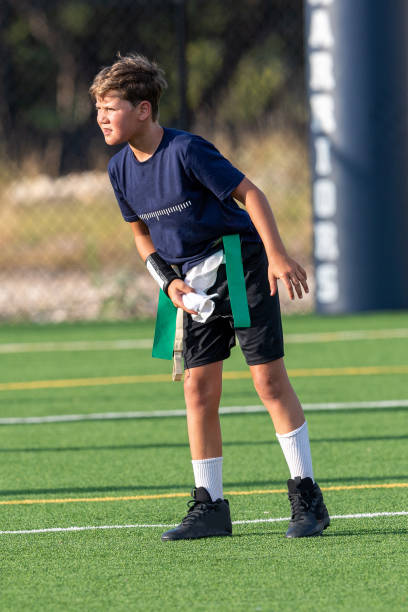 istock Young boy playing in a flag football game 1264354836