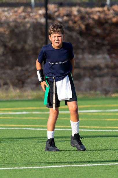 istock Young boy playing in a flag football game 1264354837