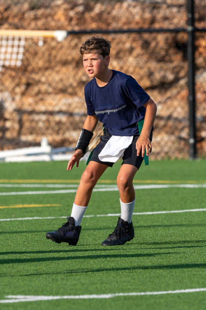 istock Young boy playing in a flag football game 1264354843