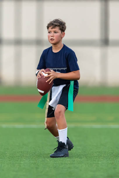 istock Young boy playing in a flag football game 1264354859