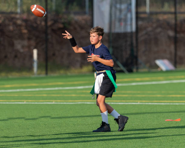 istock Young boy playing in a flag football game 1264354863