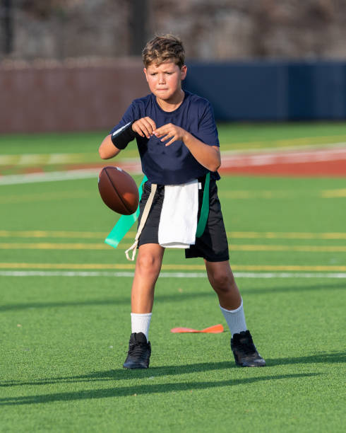 istock Young boy playing in a flag football game 1264354870