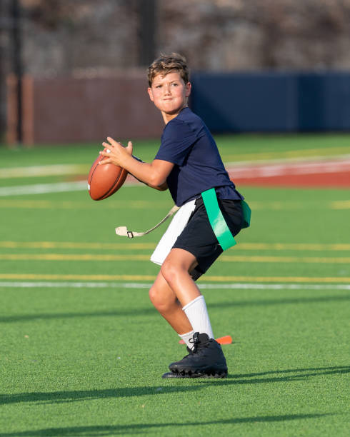 istock Young boy playing in a flag football game 1264354877