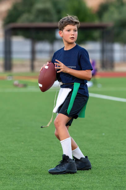 istock Young boy playing in a flag football game 1264354879