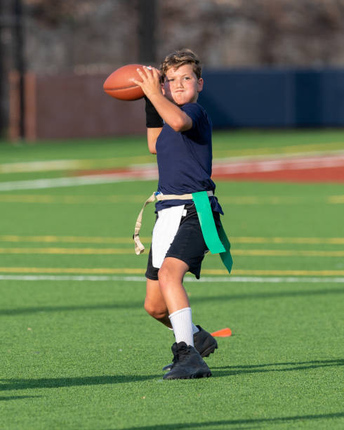 istock Young boy playing in a flag football game 1264354881