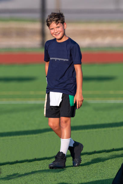 istock Young boy playing in a flag football game 1264354885