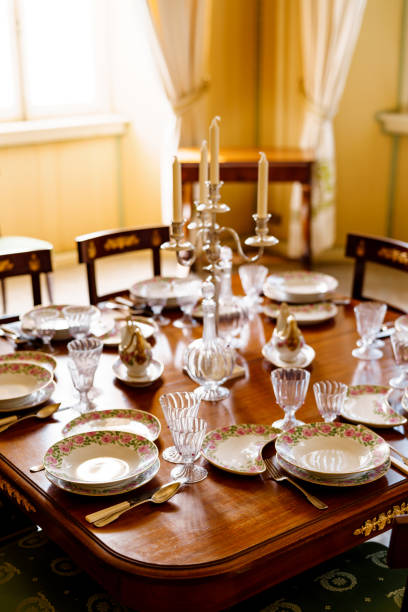 istock A festively decorated fish table with clean empty plates, spoons, knives, wine glasses, decanters and a candlestick in the center on a wooden table in the room. 1264354889