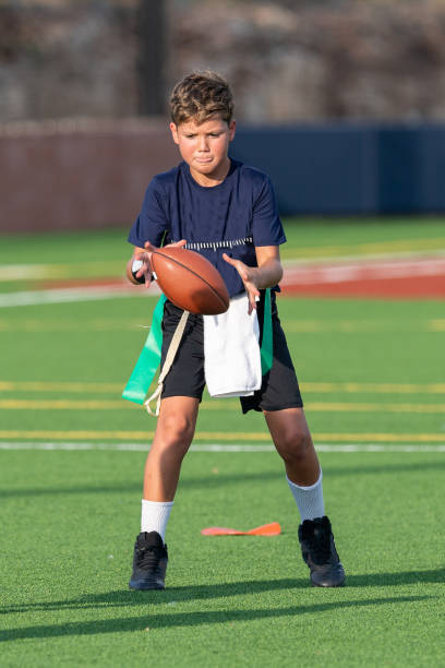 istock Young boy playing in a flag football game 1264354897