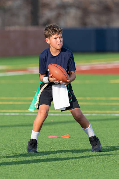 istock Young boy playing in a flag football game 1264354929