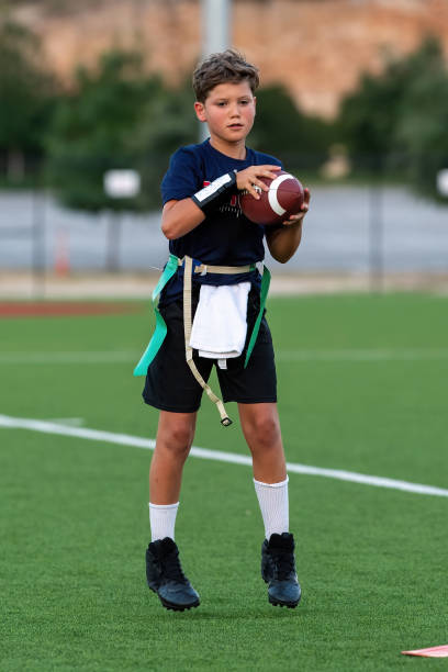istock Young boy playing in a flag football game 1264354935