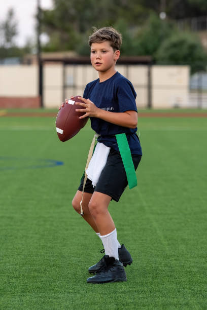 istock Young boy playing in a flag football game 1264354937