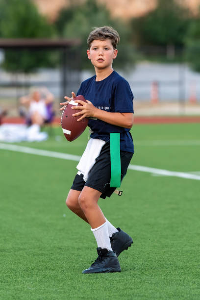 istock Young boy playing in a flag football game 1264354954