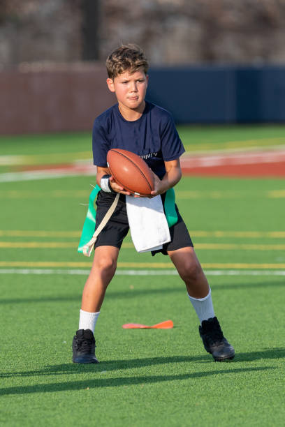 istock Young boy playing in a flag football game 1264354956