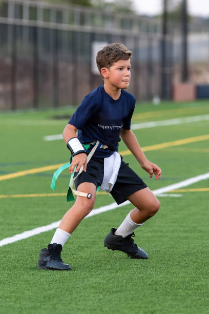 istock Young boy playing in a flag football game 1264354970