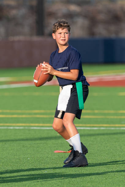 istock Young boy playing in a flag football game 1264354975