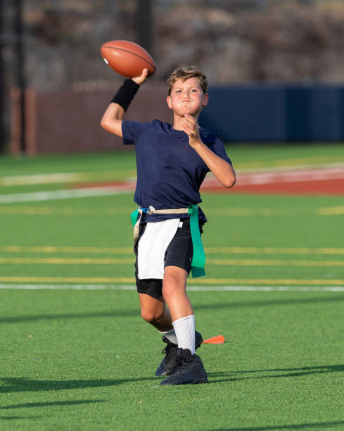 istock Young boy playing in a flag football game 1264354992