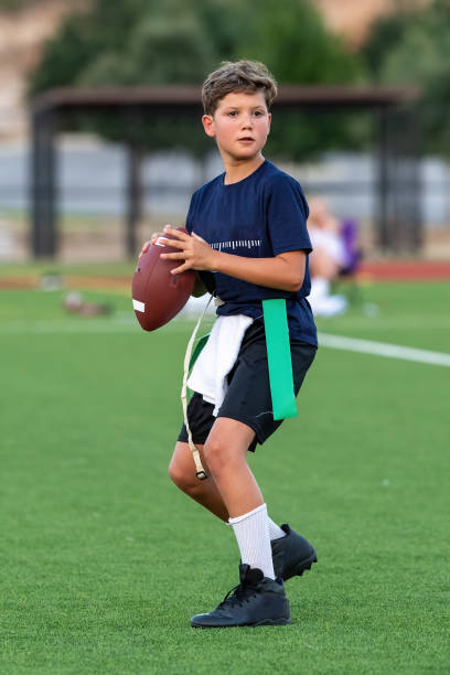 istock Young boy playing in a flag football game 1264354993