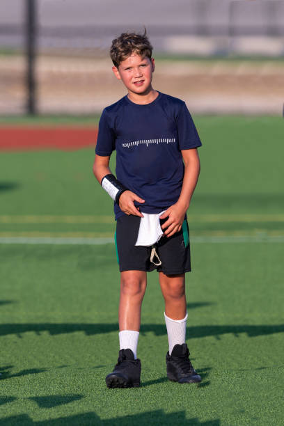 istock Young boy playing in a flag football game 1264354994