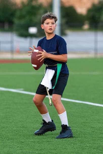 istock Young boy playing in a flag football game 1264355029