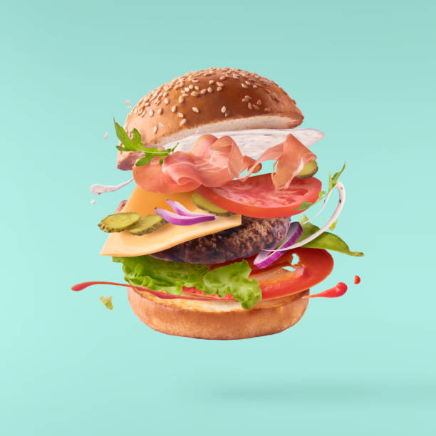 Delicious burger with flying ingredients isolated stock photo