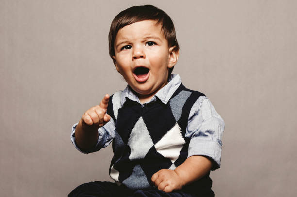 istock Angry baby boy portrait front of grey background. 1264356224