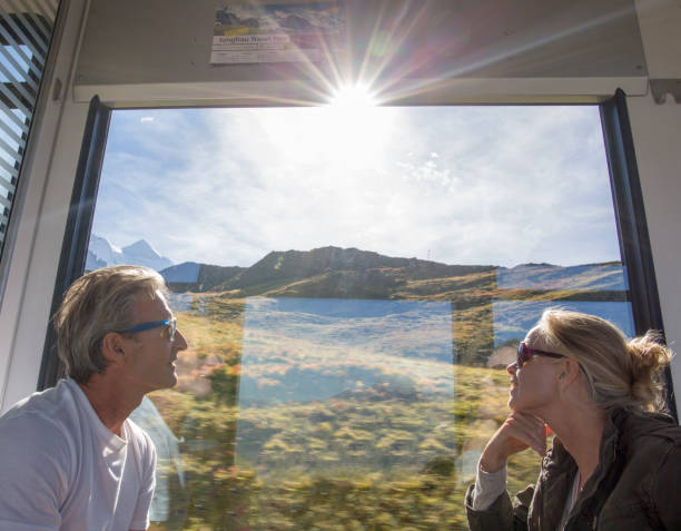 istock Mature couple in moving train enjoy the passing views 1264356366