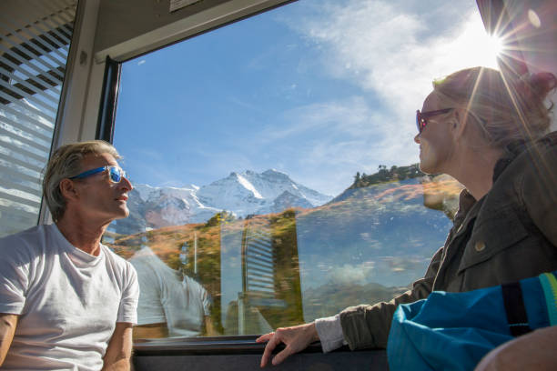 istock Mature couple in moving train enjoy the passing views 1264357013