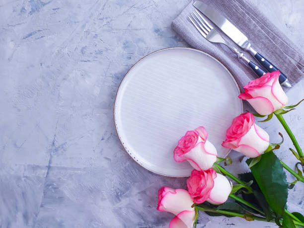 istock plate flower rose on concrete background 1264358221