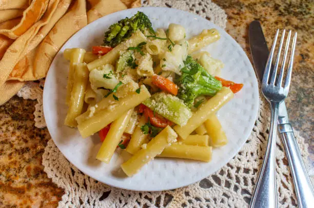 Vegetarian Italian ziti pasta primavera with white wine garlic sauce